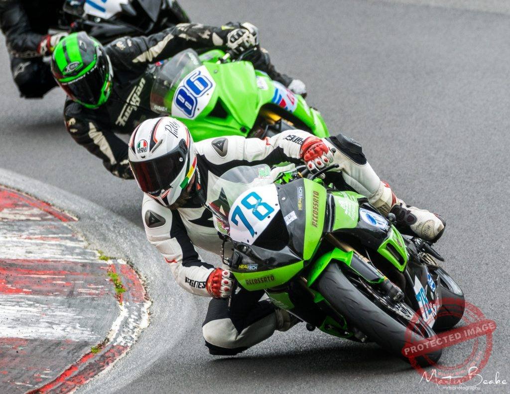 Three Motorcycles compete around Druids Corner at Brands Hatch