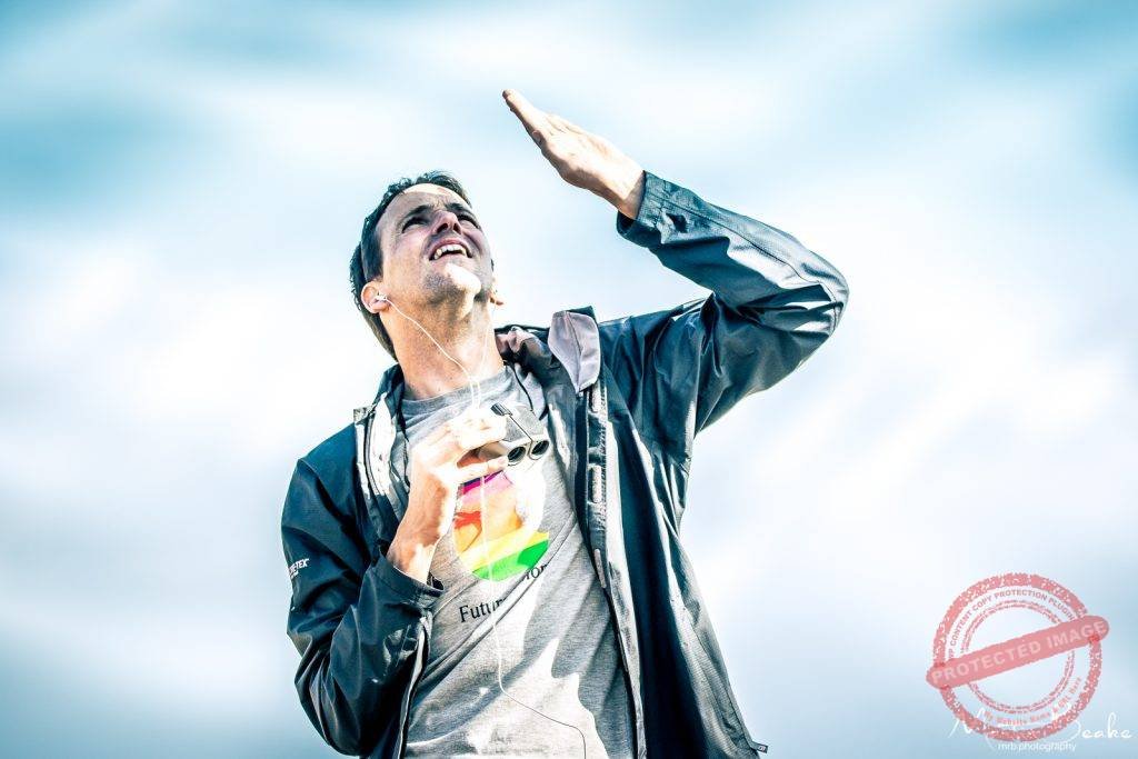 Man looking up at the skies holding binoculars