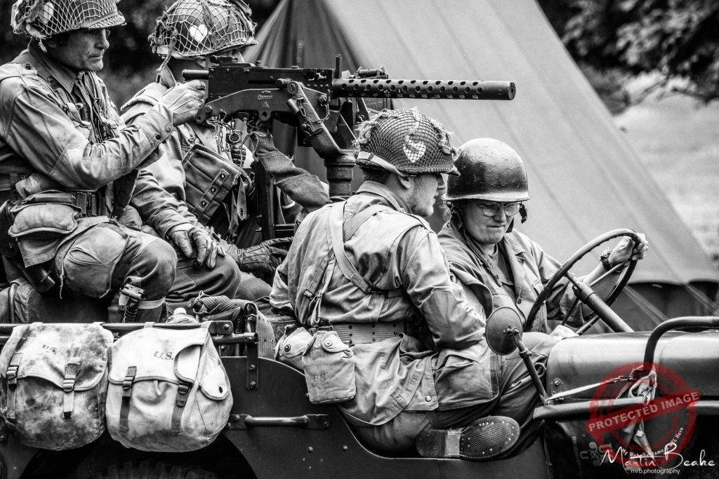 Four World War II Re-Enactors in Jeep