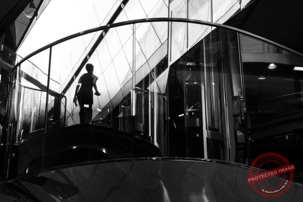 Reflections of a person in window in a London City shopping centre