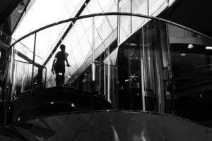 Reflections of a person in window in a London City shopping centre